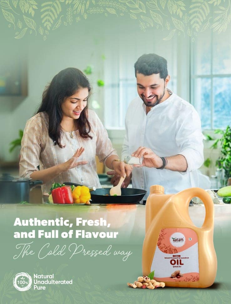 A couple wearing aprons cooks together in a rustic kitchen.